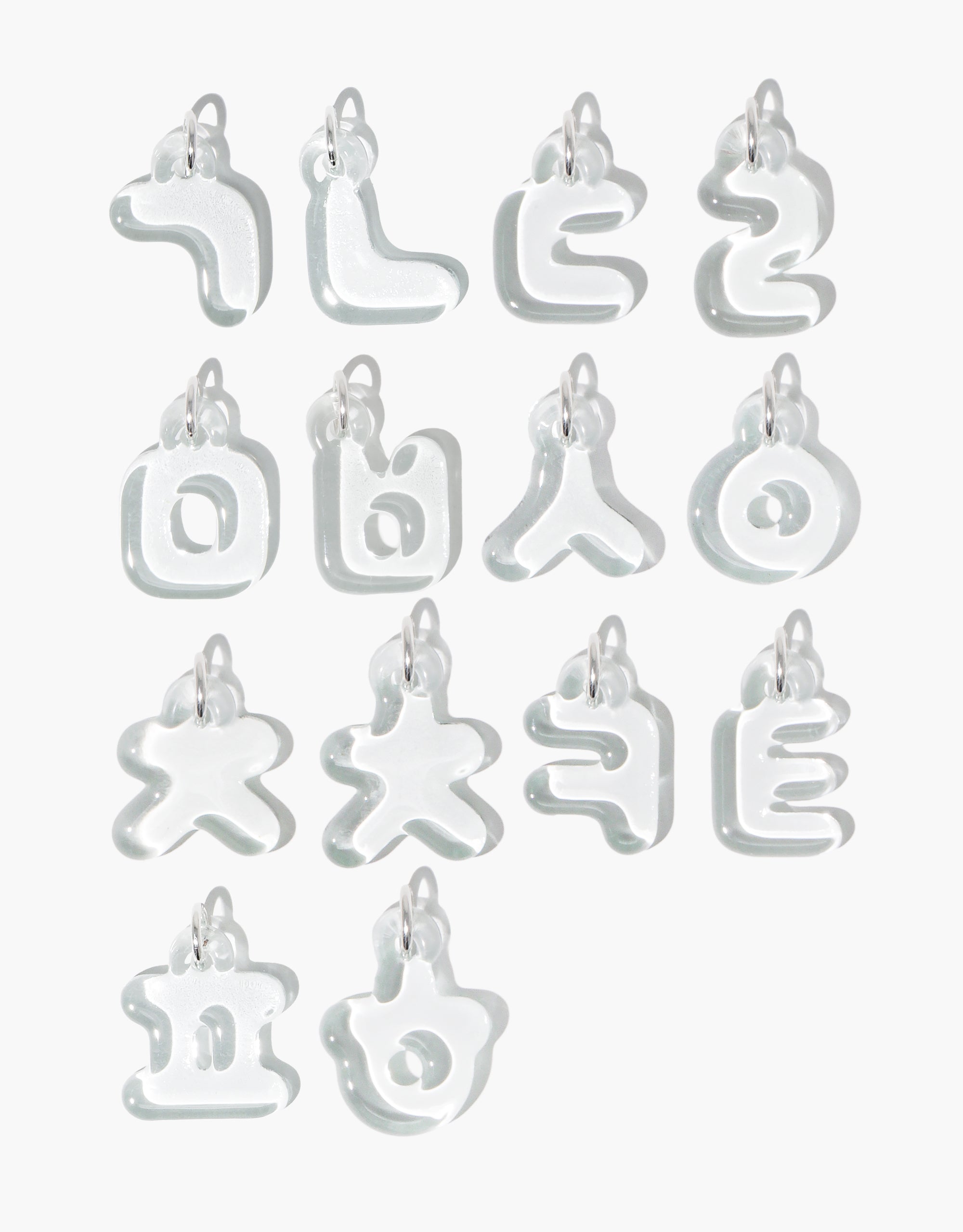 Transparent glass Hangul alphabet charms arranged in rows, showcasing Korean letters in a bubble-like design. Each charm features a unique character with rounded edges and a small loop for attachment. Letter Charm | 한글 Hangul by CLED