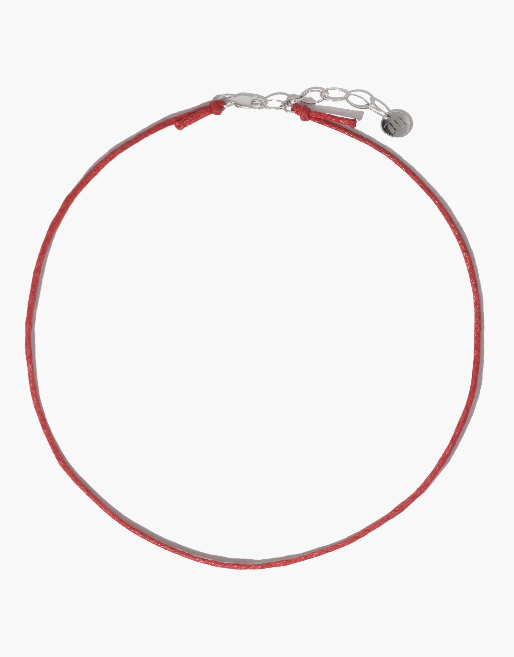 Adjustable red cotton cord necklace with silver clasp and extender chain, ideal for attaching charms. Versatile 16-18 inch length. Minimalist design perfect for layering or wearing solo. Sustainably crafted accessory. Cord Necklace by CLED.