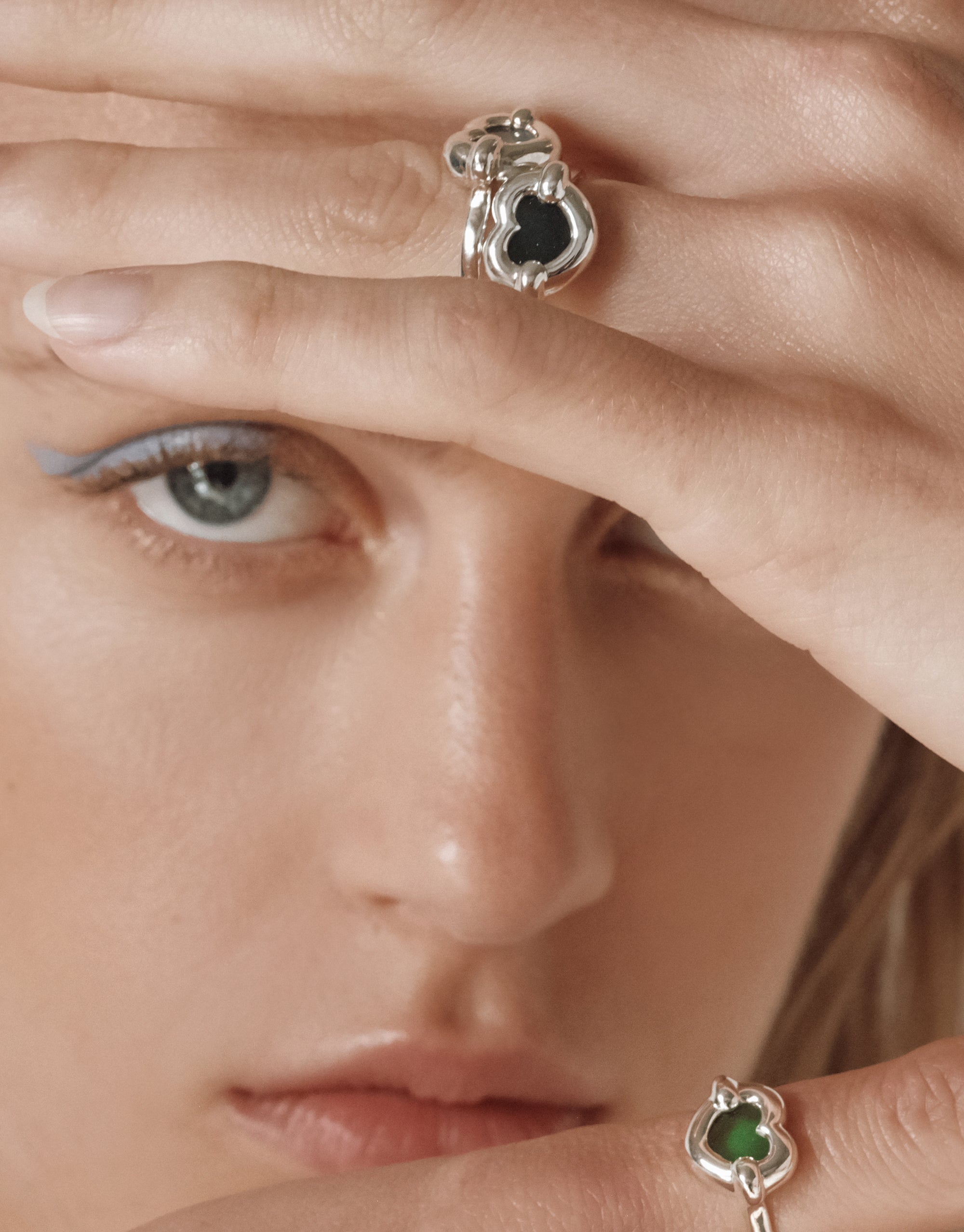 Core Heart Ring | Small: A close-up of a woman's hand showcasing a sleek, sculptural silver ring with a smooth, puffy design, embodying minimalist elegance and eco-conscious craftsmanship.