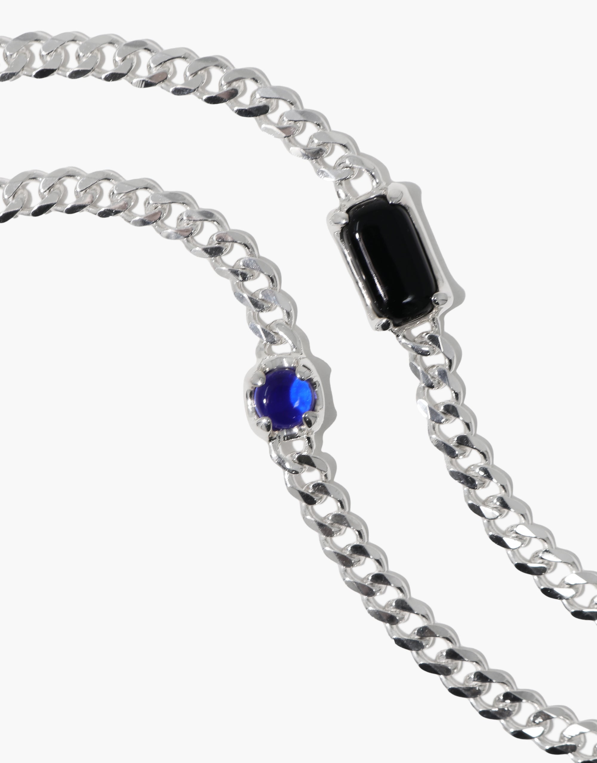 Prism Bracelet featuring a silver chain with striking blue and black Eco Gems, crafted from upcycled glass, showcasing CLED's eco-conscious jewelry artistry.