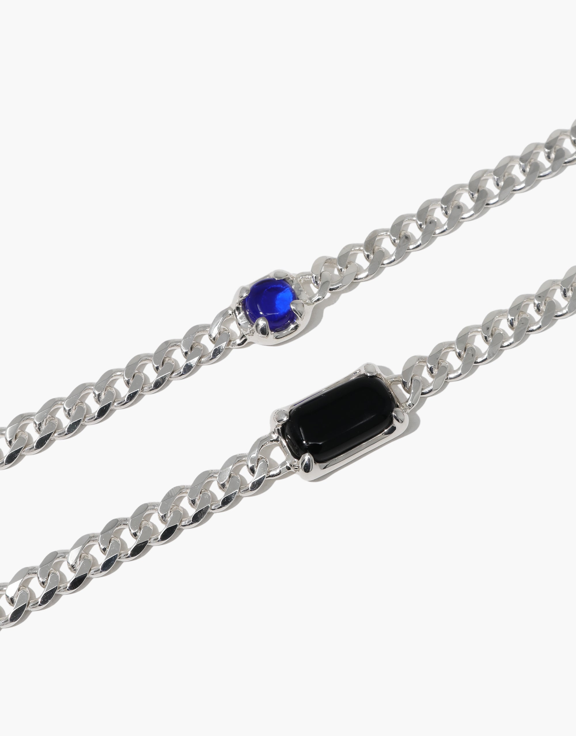 Prism Bracelet featuring a silver chain adorned with two hand-formed blue Eco Gems, upcycled from discarded glass, reflecting CLED's eco-conscious design ethos.