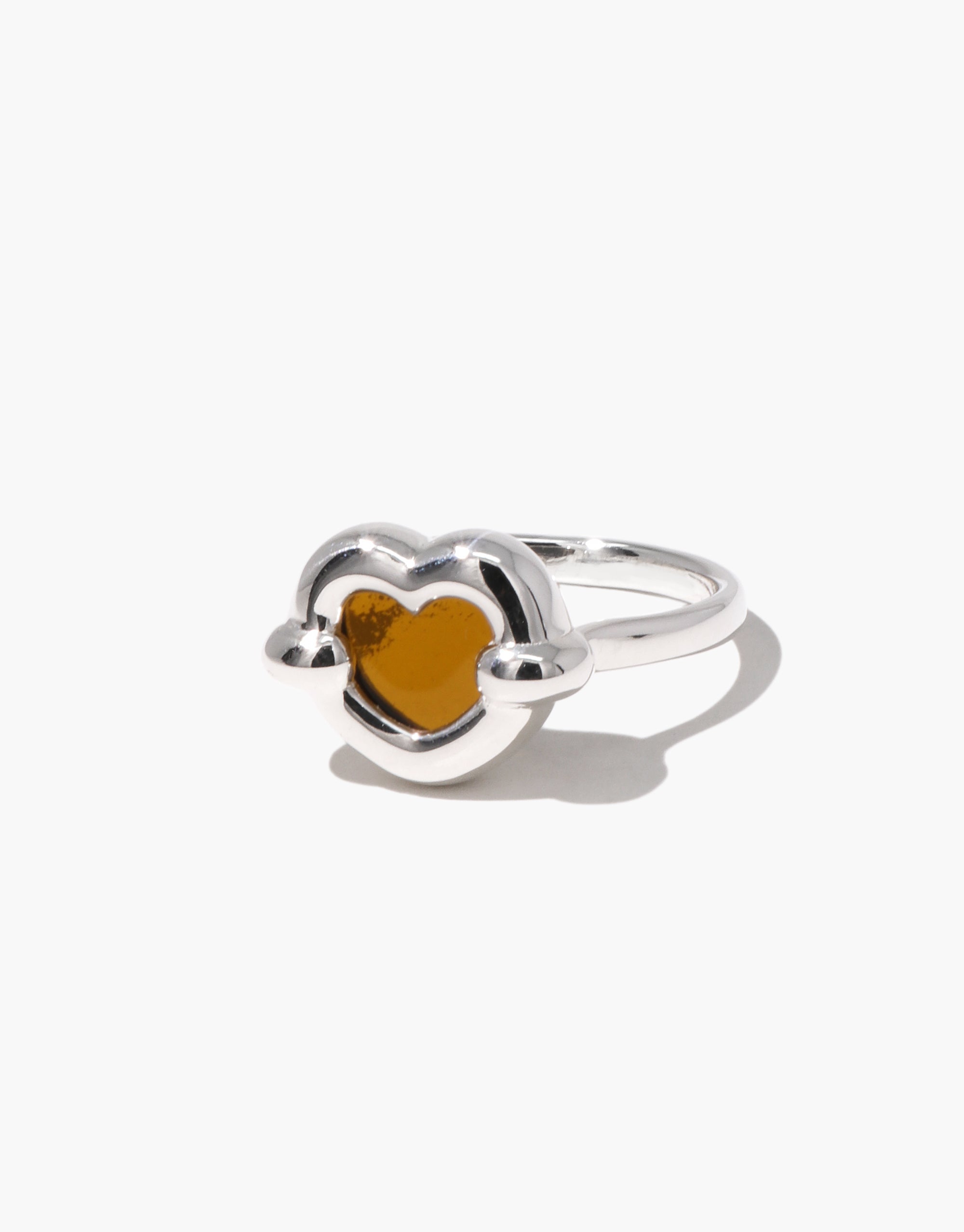 Core Heart Ring | Small: A silver ring featuring a brown heart, showcasing a seamless, sculptural design. Minimal yet bold, this eco-conscious piece from CLED adds a modern touch to any outfit.